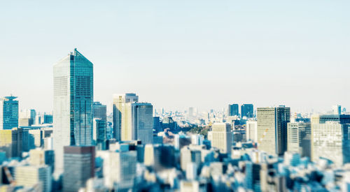 Modern buildings in city against clear sky