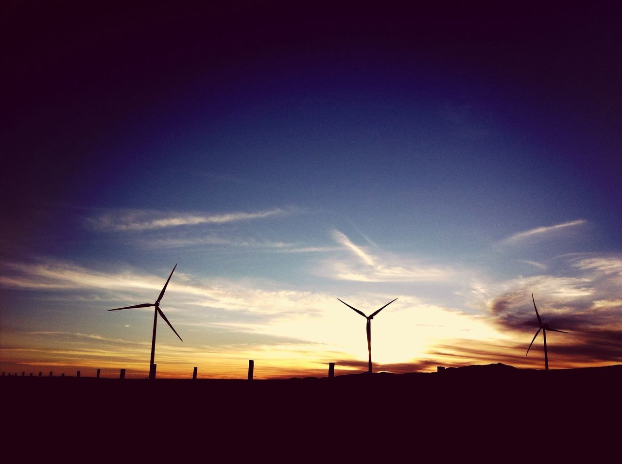 sunset, silhouette, fuel and power generation, landscape, sky, wind turbine, field, wind power, alternative energy, environmental conservation, tranquil scene, tranquility, renewable energy, windmill, scenics, electricity pylon, nature, beauty in nature, rural scene, technology