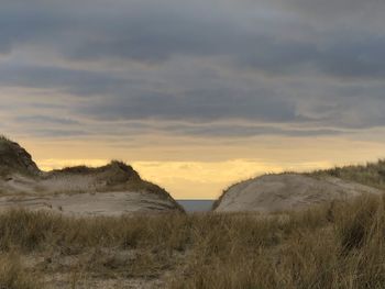 Scenic view of field against sky during sunset