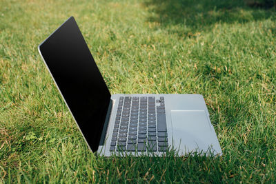 Laptop on grassy field
