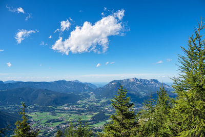 Scenic view of mountains against blue sky