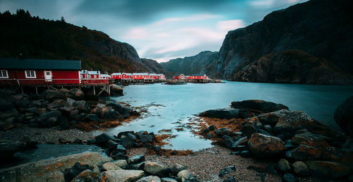 Scenic view of sea and mountains against sky