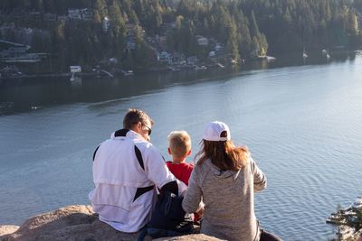 Rear view of people enjoying in lake