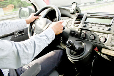 Low section of man sitting in car