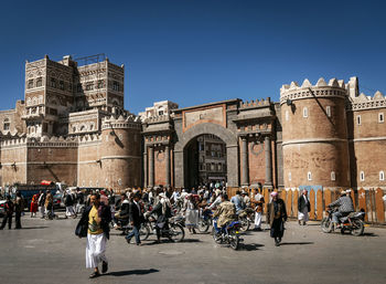 Group of people against building in city