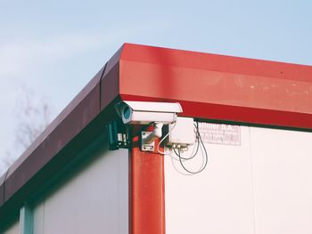 Low angle view of electric lamp against sky