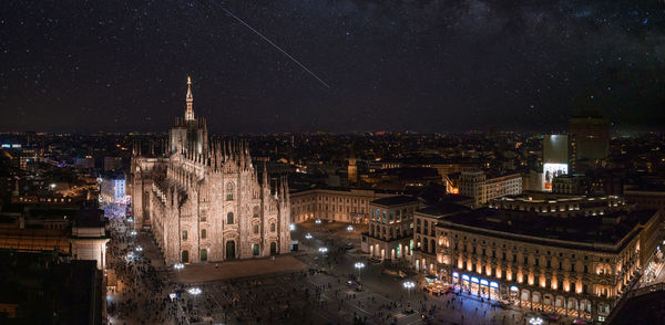 Aerial view of piazza duomo in front of the gothic cathedral in the center of milan at night.