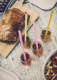 High angle view of bread loaf and elderflower drinks