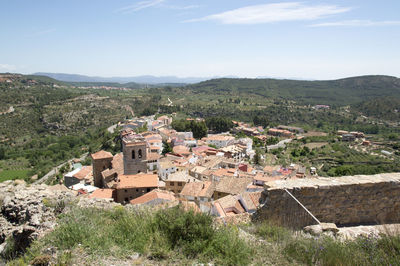 Houses on mountain against sky