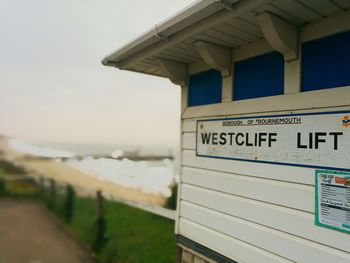 Text on beach against sky