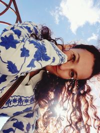 Portrait of smiling woman against sky