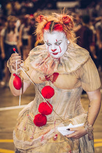 Midsection of woman holding red berries