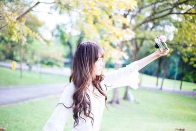 Portrait of woman standing on smart phone