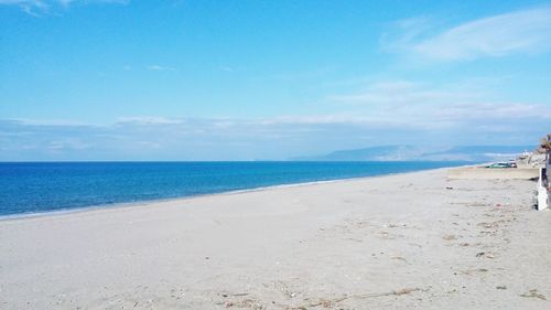 View of beach against blue sky