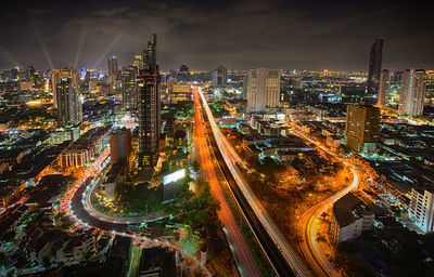 Aerial view of illuminated buildings in city at night