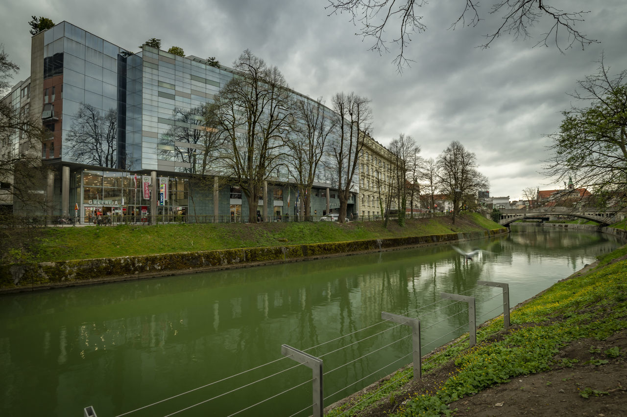 reflection, water, architecture, waterway, built structure, canal, cloud, tree, building exterior, sky, plant, urban area, nature, building, city, no people, cityscape, house, outdoors, residential district, rural area, environment