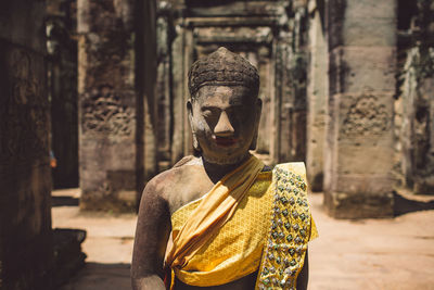 Statue outside temple against building