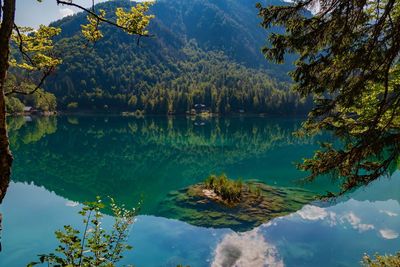 Scenic view of lake and mountains against sky