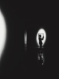Woman standing in illuminated room