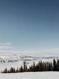 Scenic view of snowcapped mountains against blue sky