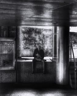 Rear view of a man sitting on bench