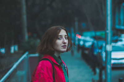 Portrait of woman looking away while standing outdoors