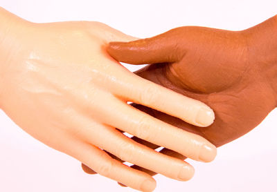 Close-up of woman hand over white background