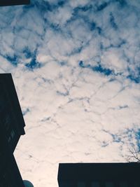 Low angle view of building against cloudy sky