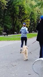 Man with dog on footpath in park