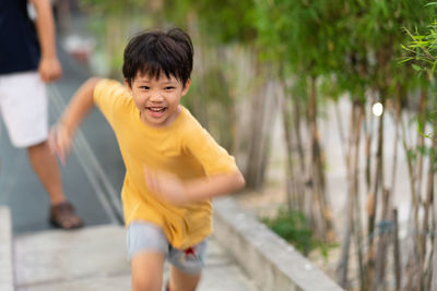 Boy running on footpath at park