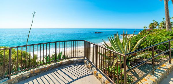 Scenic view of swimming pool by sea against sky