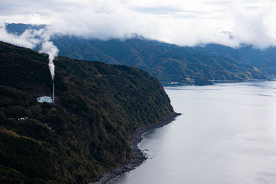 Scenic view of sea and mountains against sky