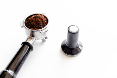 High angle view of coffee cup on white background