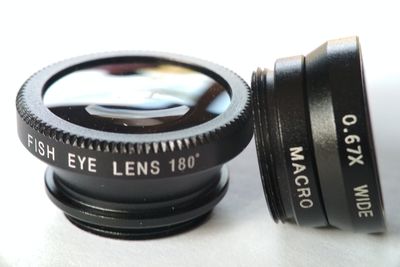 Close-up of camera on table against white background