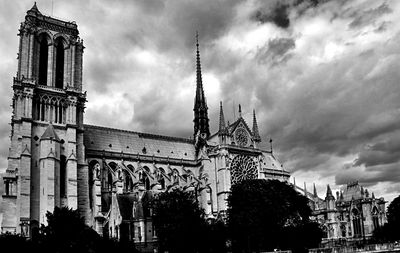 Low angle view of building against cloudy sky