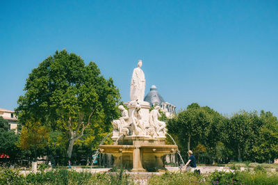 Low angle view of statue against clear blue sky