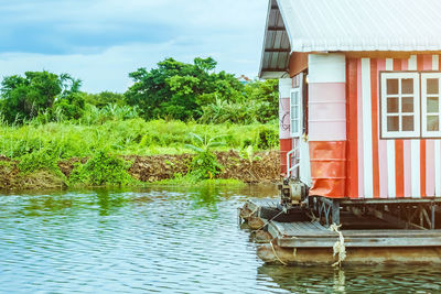 House by lake against building