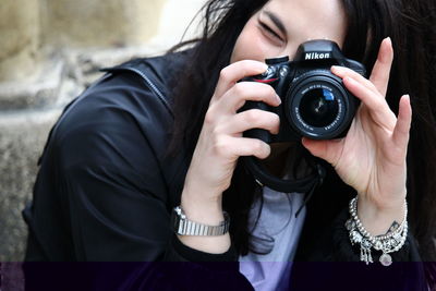 Portrait of woman photographing