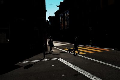 Man walking on road at night