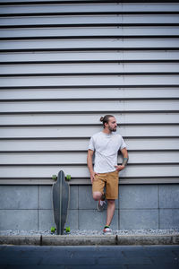Boy posing with skateboard in hand