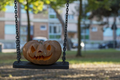 Close-up of swing hanging on playground