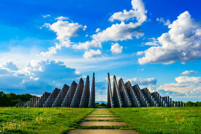 Panoramic view of field against cloudy sky