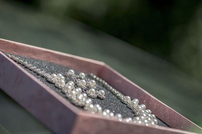 Close-up of pearl necklace in box on table