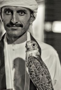 Portrait of man against bird