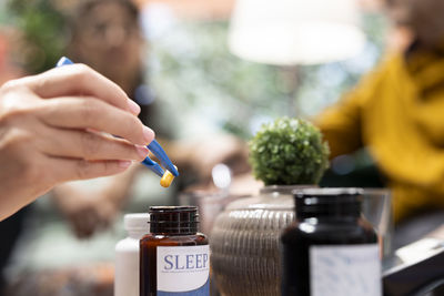 Close-up of man holding bottle