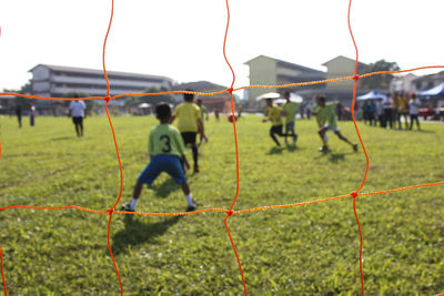 Children playing soccer on field