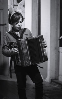 Full length of boy playing accordion