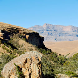 Scenic view of rocky mountains against clear blue sky