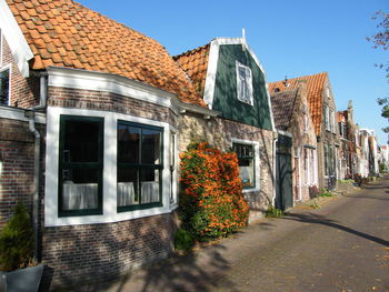 Street by buildings against sky