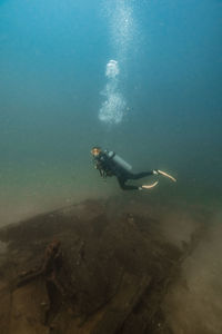 Scuba diver diving undersea at del coco beach